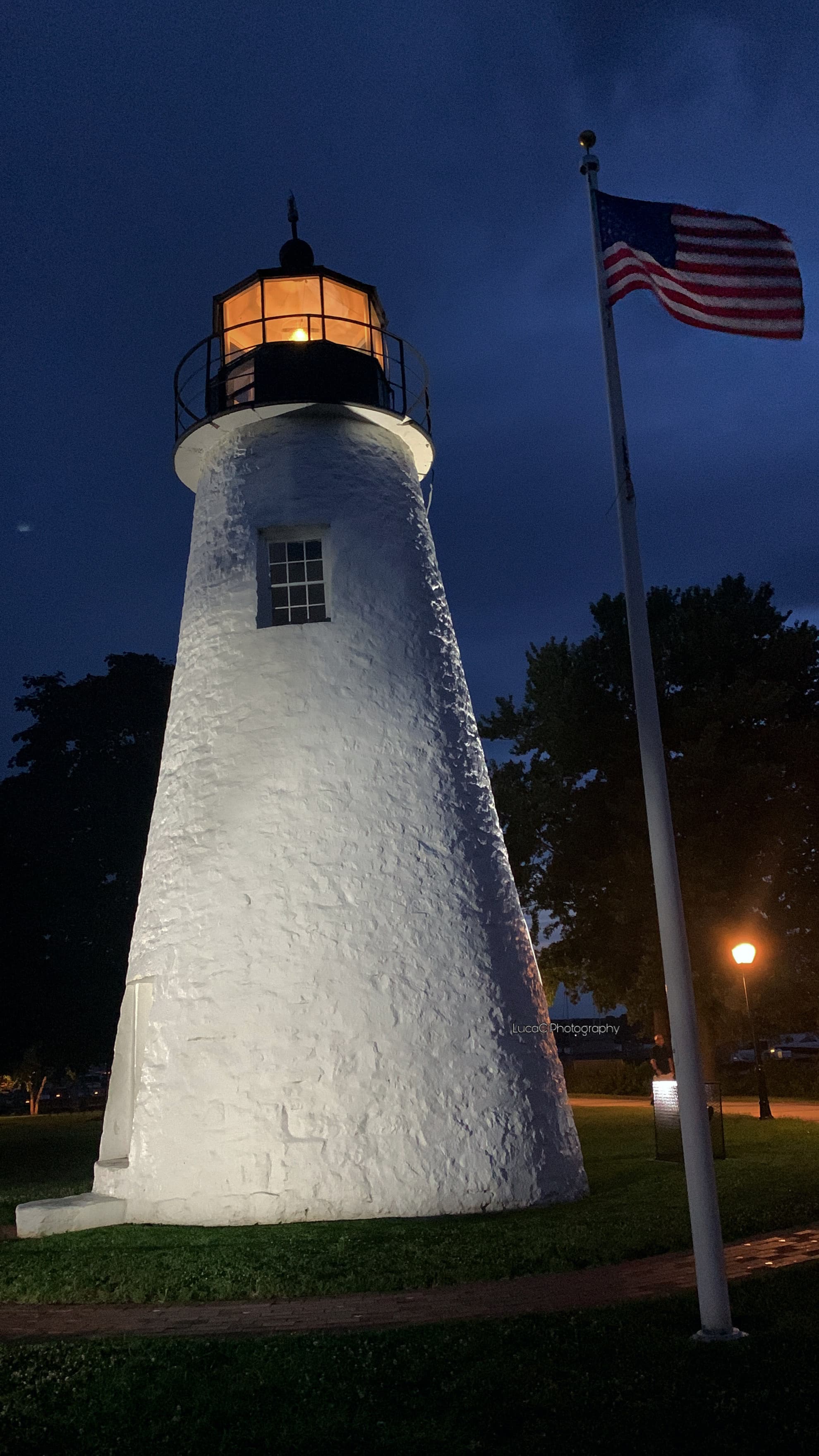 Havre de Grace’s lighthouse with the American flag blowing in the wind.