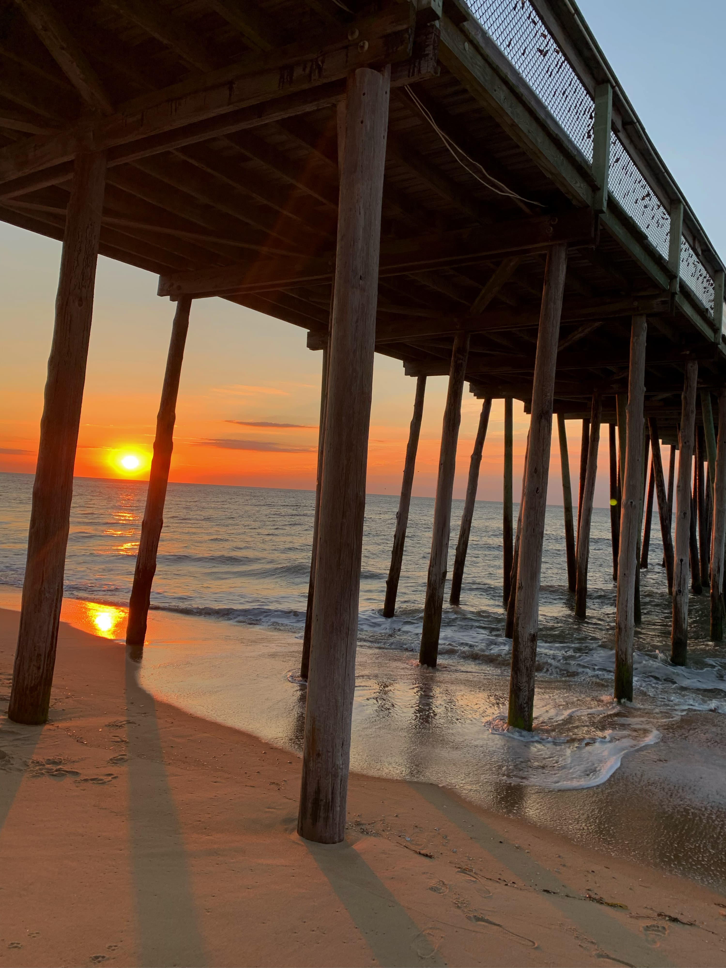 A beautiful orange sunrise captured from under the pier in OC.