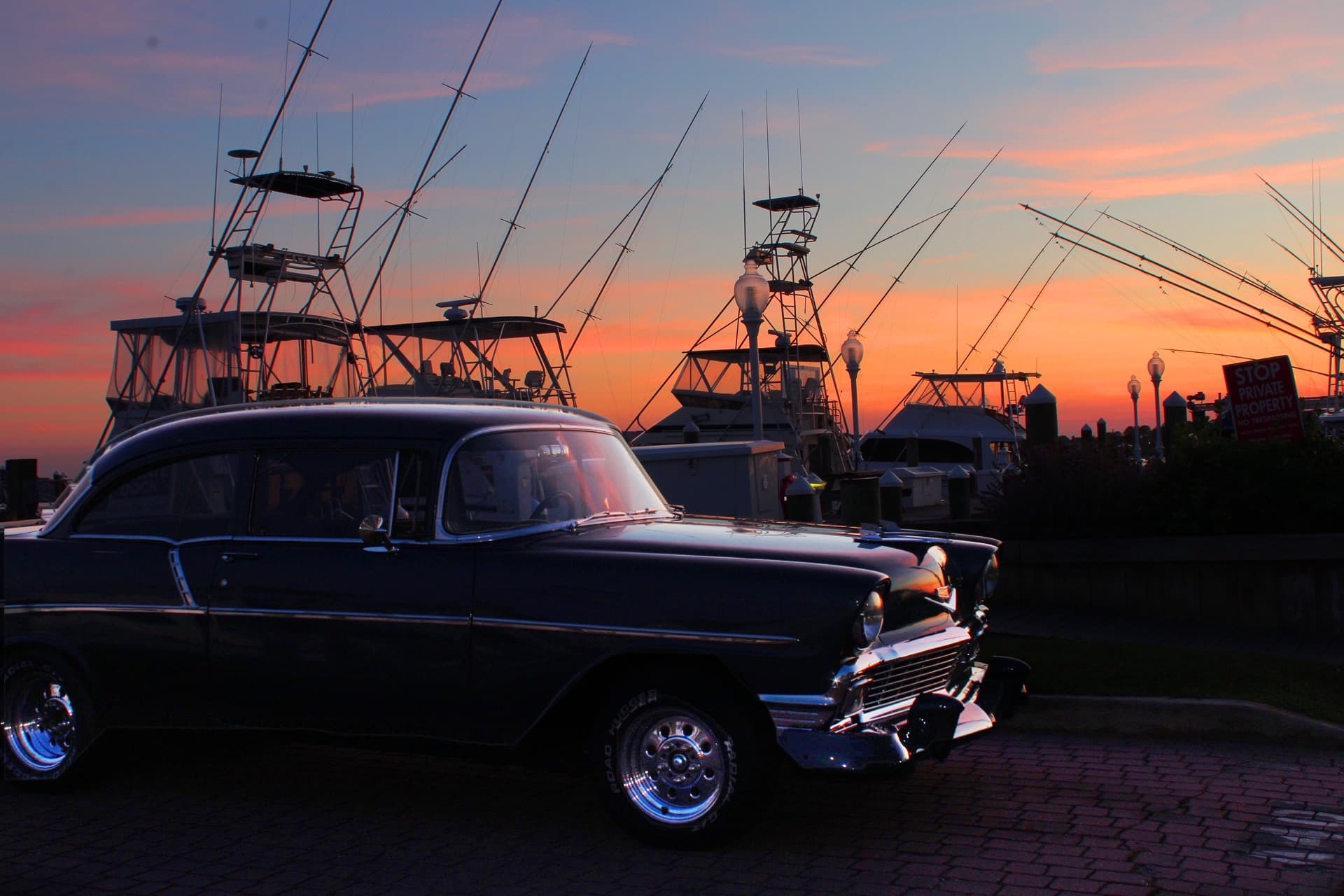 A view of a sunset at the White Marlin Marina reflecting off a vintage Chevy Bel Air.