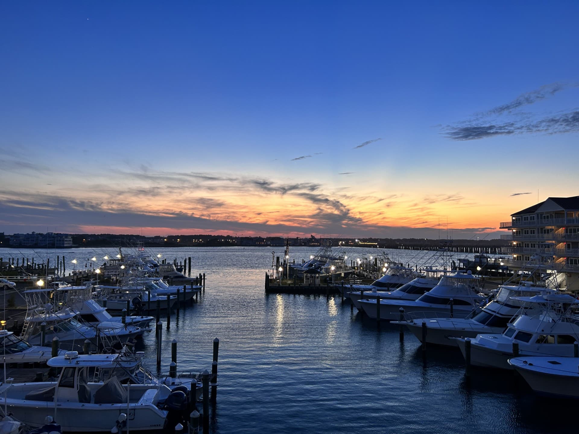 White Marlin Marina in OC, MD at dusk with a beautiful blue sky.